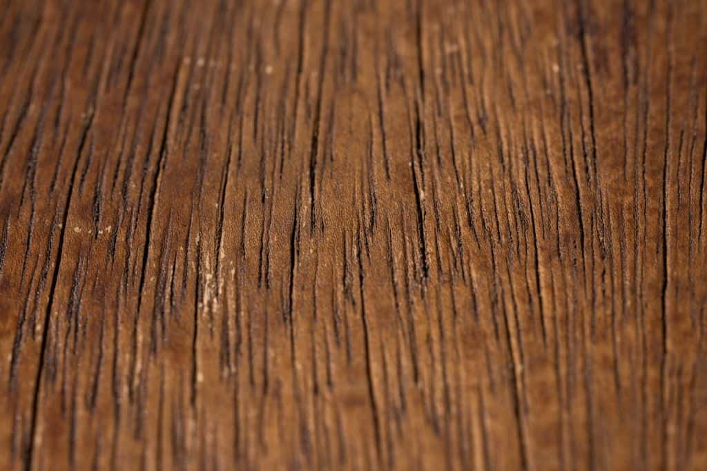 Detailed close-up of a rustic wooden surface showing natural grain and texture.